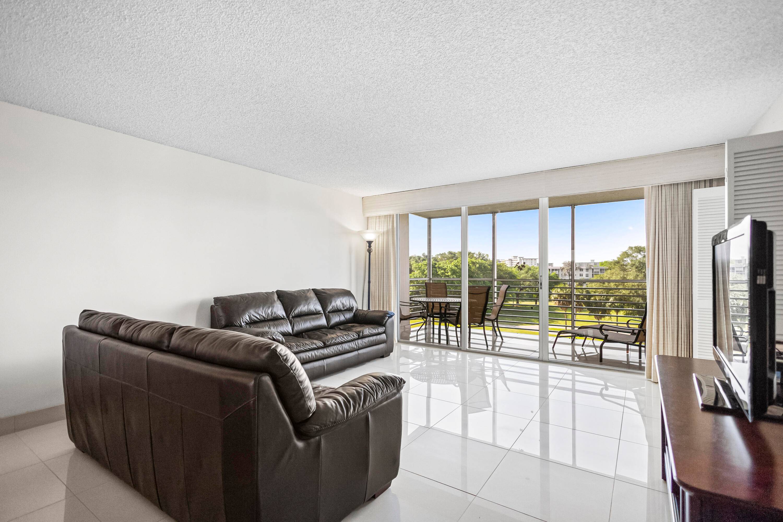 Panoramic golf course views surround this expansive CORNER residence, where natural light pours in from its coveted southern exposure.