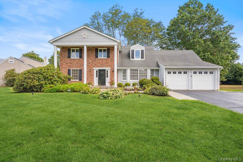 Beautifully Renovated Center Hall Colonial with Poolside Living in Woodbury.