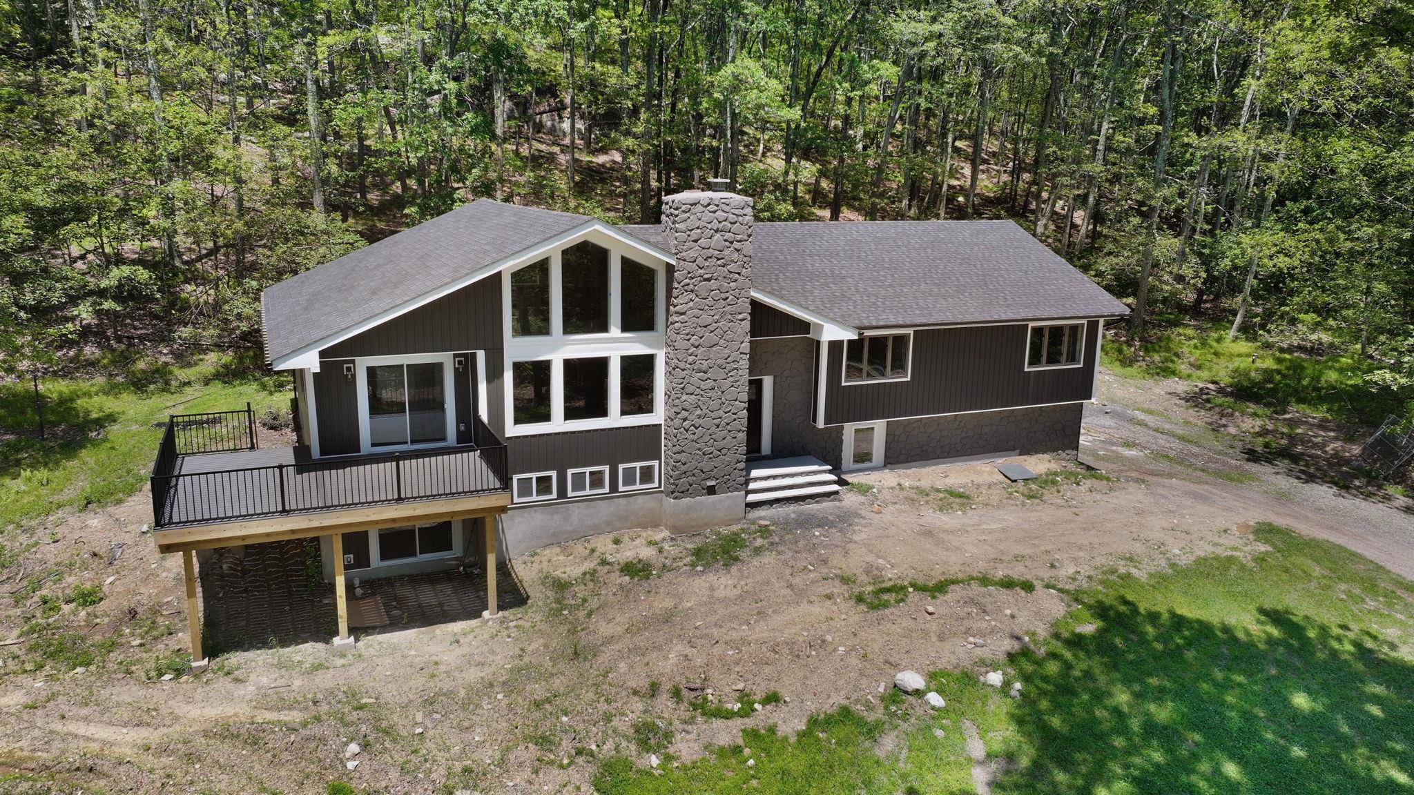 Set in the desirable Pine Bush School District, this 3, 300 sq ft custom Raised Ranch Chalet style home on aprox 3 acres blends rustic charm with modern sophistication.