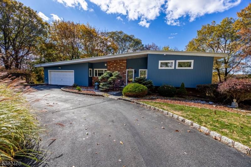 A RARE FIND ! Discover this California Contemporary Split Level perfectly nestled on 1.