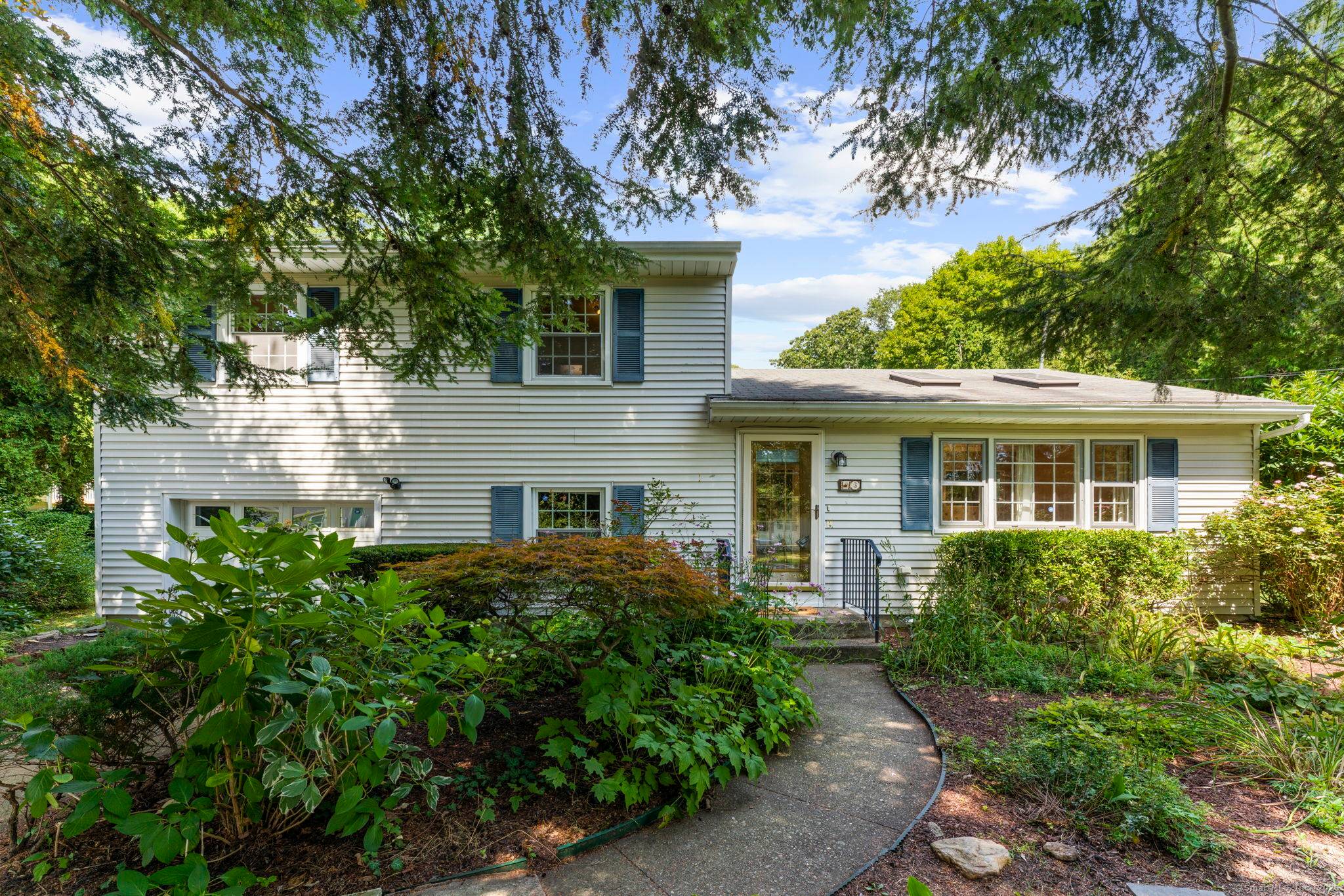 Welcome to this Quaker Hill classic split level home offering three bedrooms and three full bathrooms, set on a lovely lot with a beautiful yard.