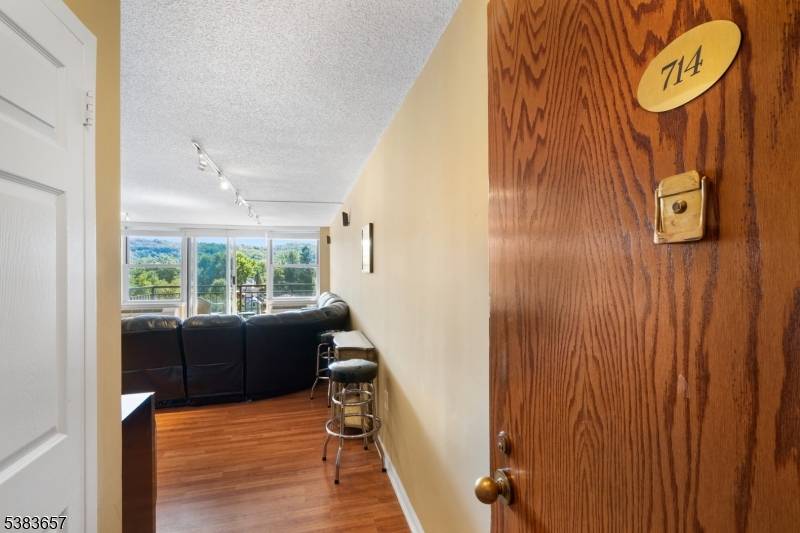 Perched on the seventh floor, this corner unit at The Mill showcases sweeping treetop and direct river views.