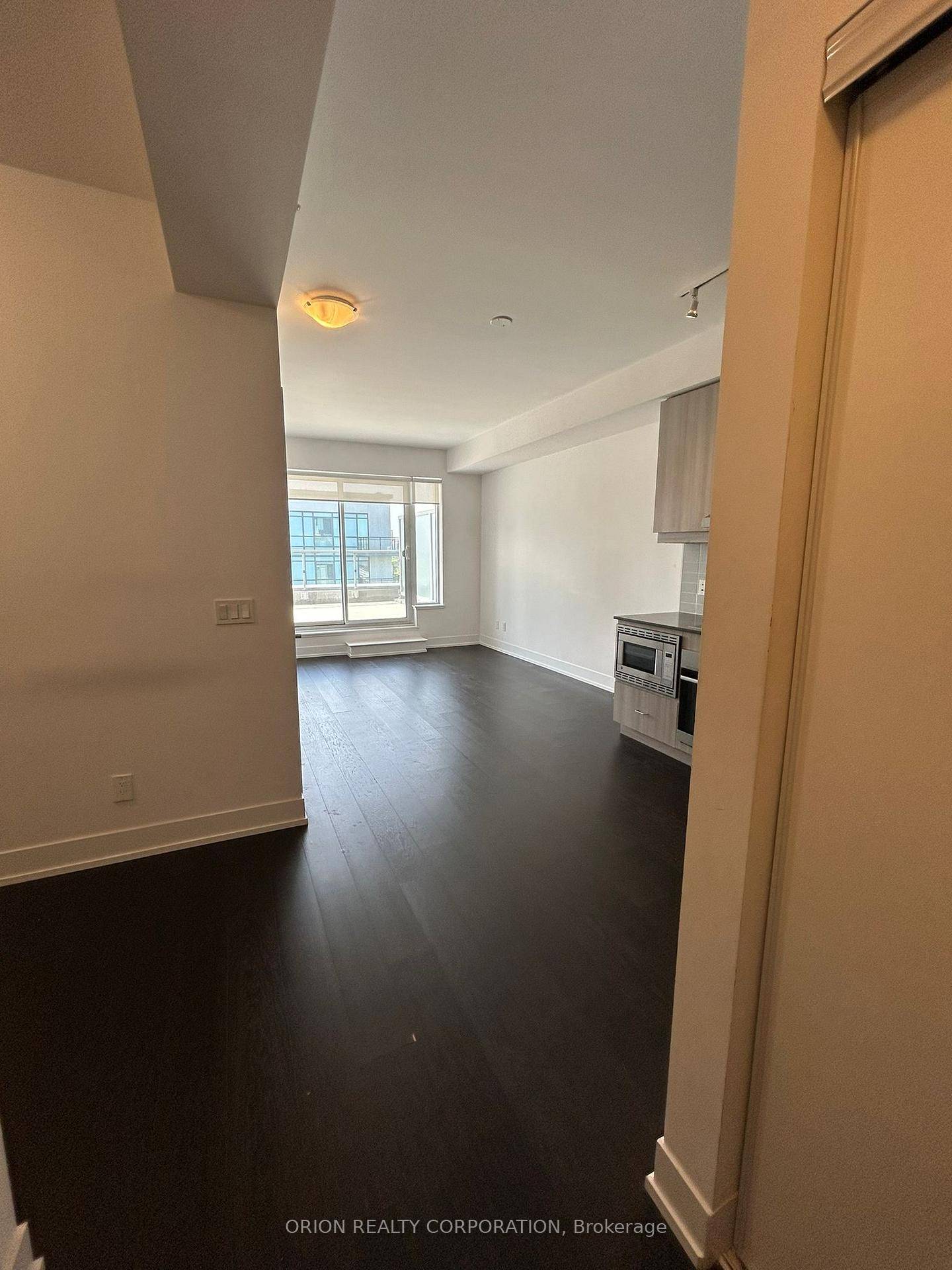 Discover the spacious living area of this 1 bedroom plus den unit at Lotus Condominiums.