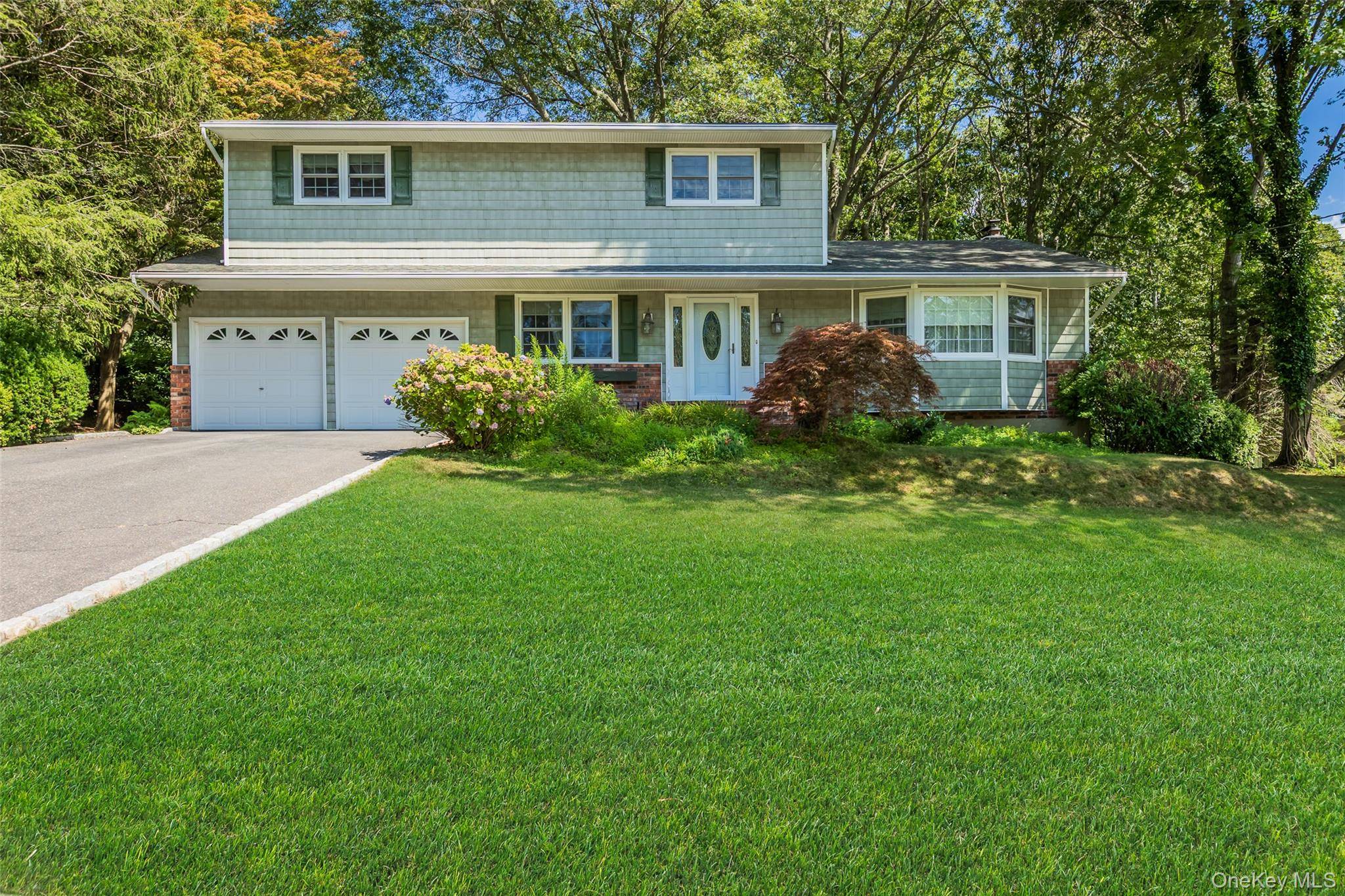 Welcome to this wonderful spacious center hall colonial on a private lot in the heart of Setauket !