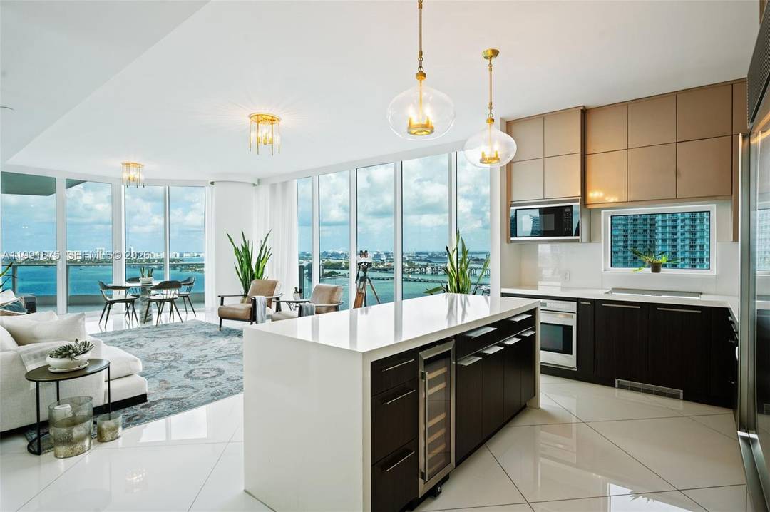 Arrive by private elevator to your personal foyer and step into a light filled, glass walled residence where the open kitchen, living, and dining areas immediately draw your eyes to ...