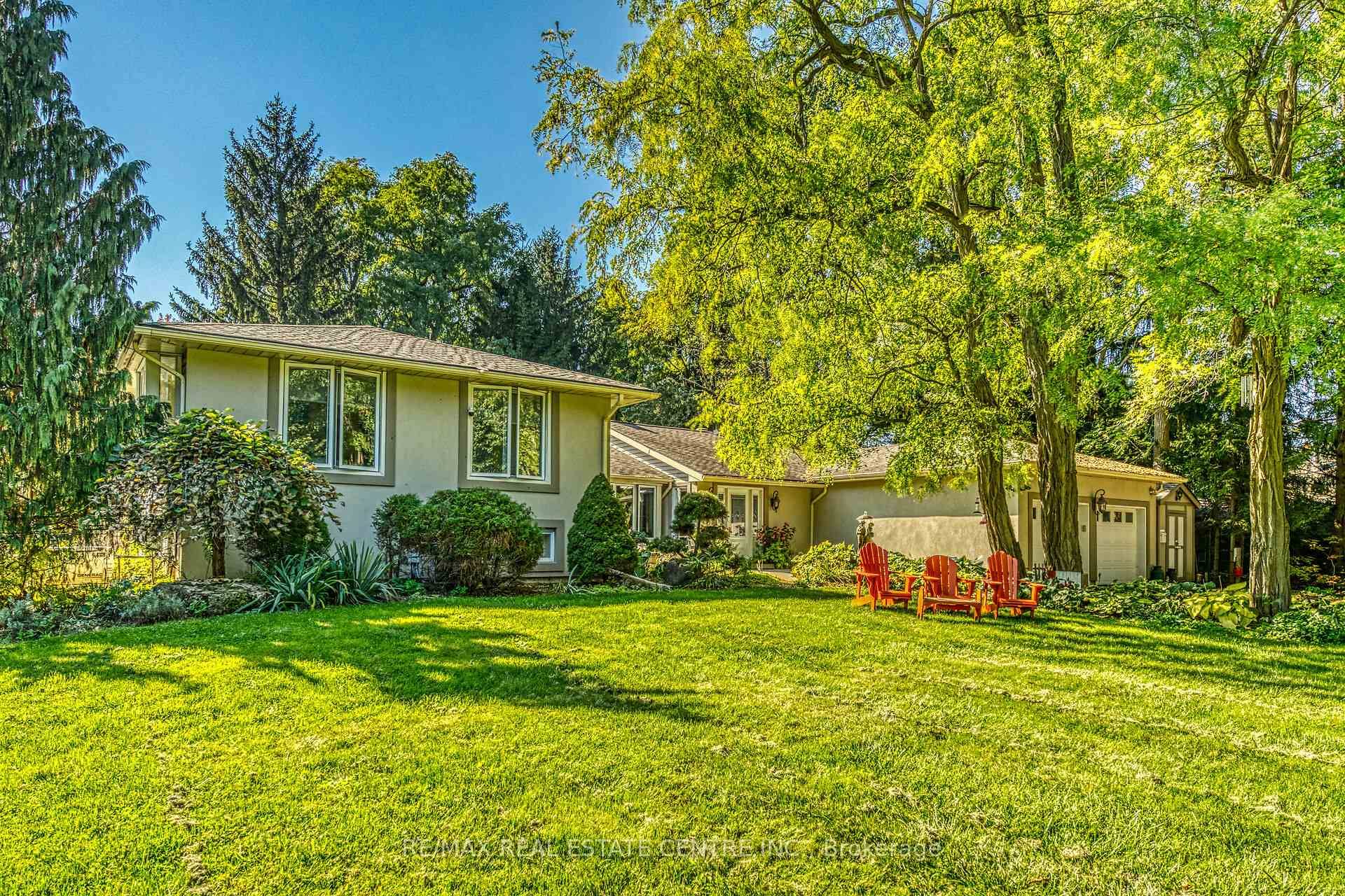 Welcome to a rare opportunity to own a stunning estate nestled on nearly 2 acres of beautifully landscaped, forest surrounded land.