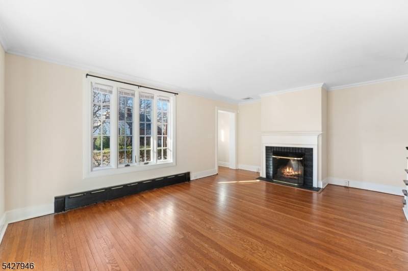 One block to Ridgewood Train Station Three level Tudor duplex 4 BR 2.