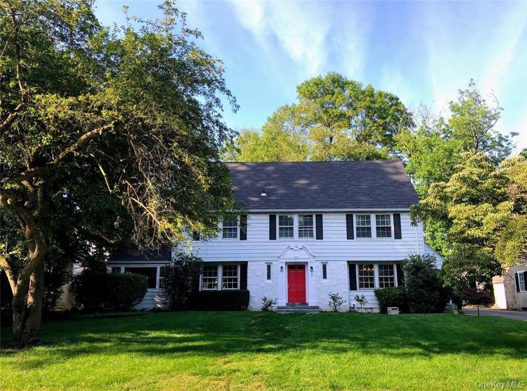 Charming six bedroom Center Hall Colonial with high end renovated eat in kitchen with sliders to backyard, renovated primary bath and hall bath.
