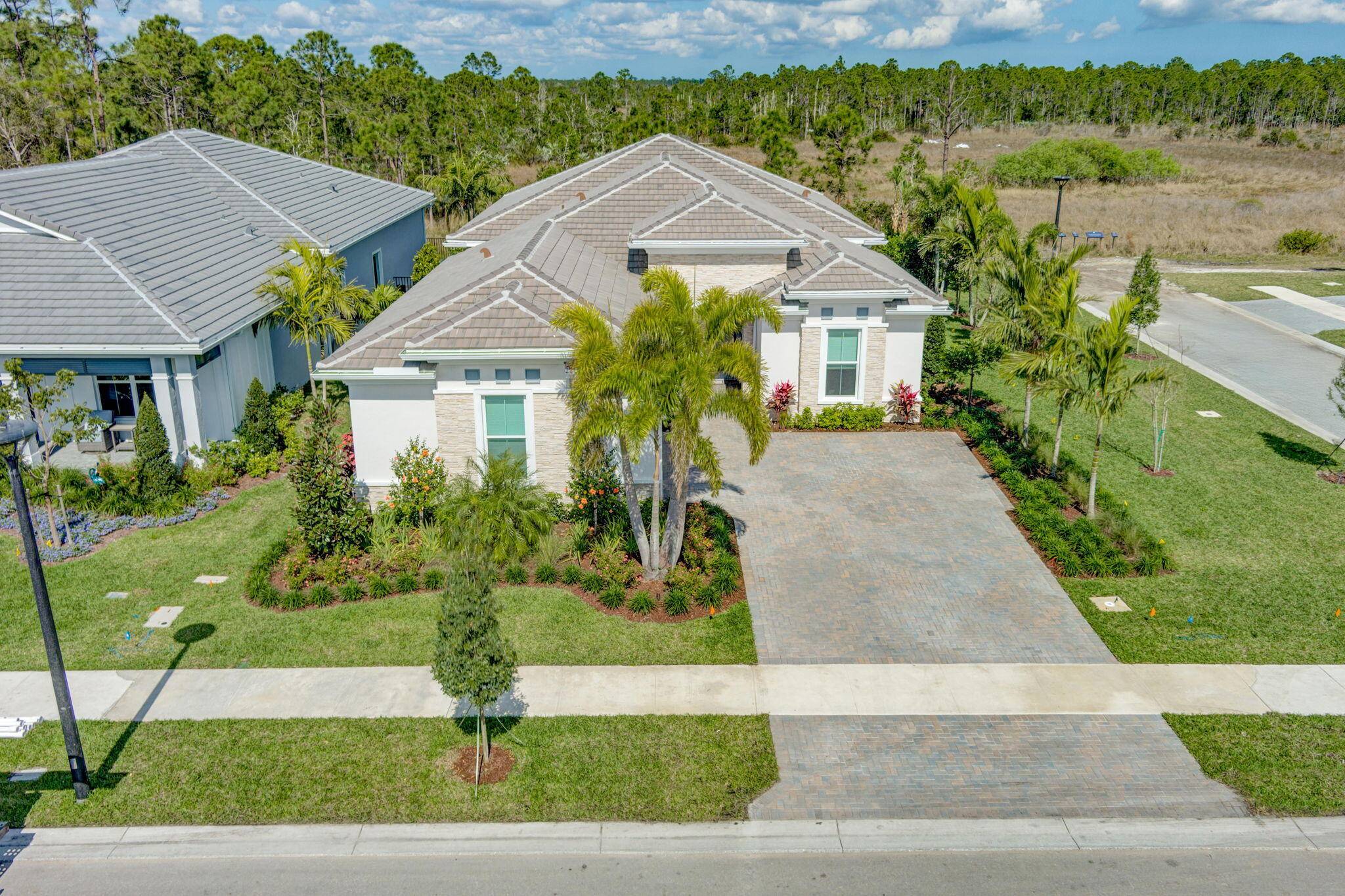 Nestled on one of the largest and private corner lots in the community, this stunning home is located in the exclusive, manned gated community of Regency at Avenir.