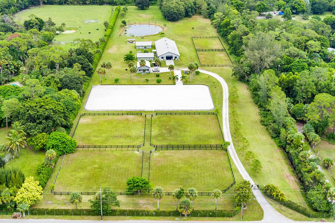 Beautiful 10 acre property with center aisle poured concrete barn 8 supersized stalls, all with hurricane shutters and screens, 2 wash stalls, full bathroom, tack room, 2 utility feed rooms, ...