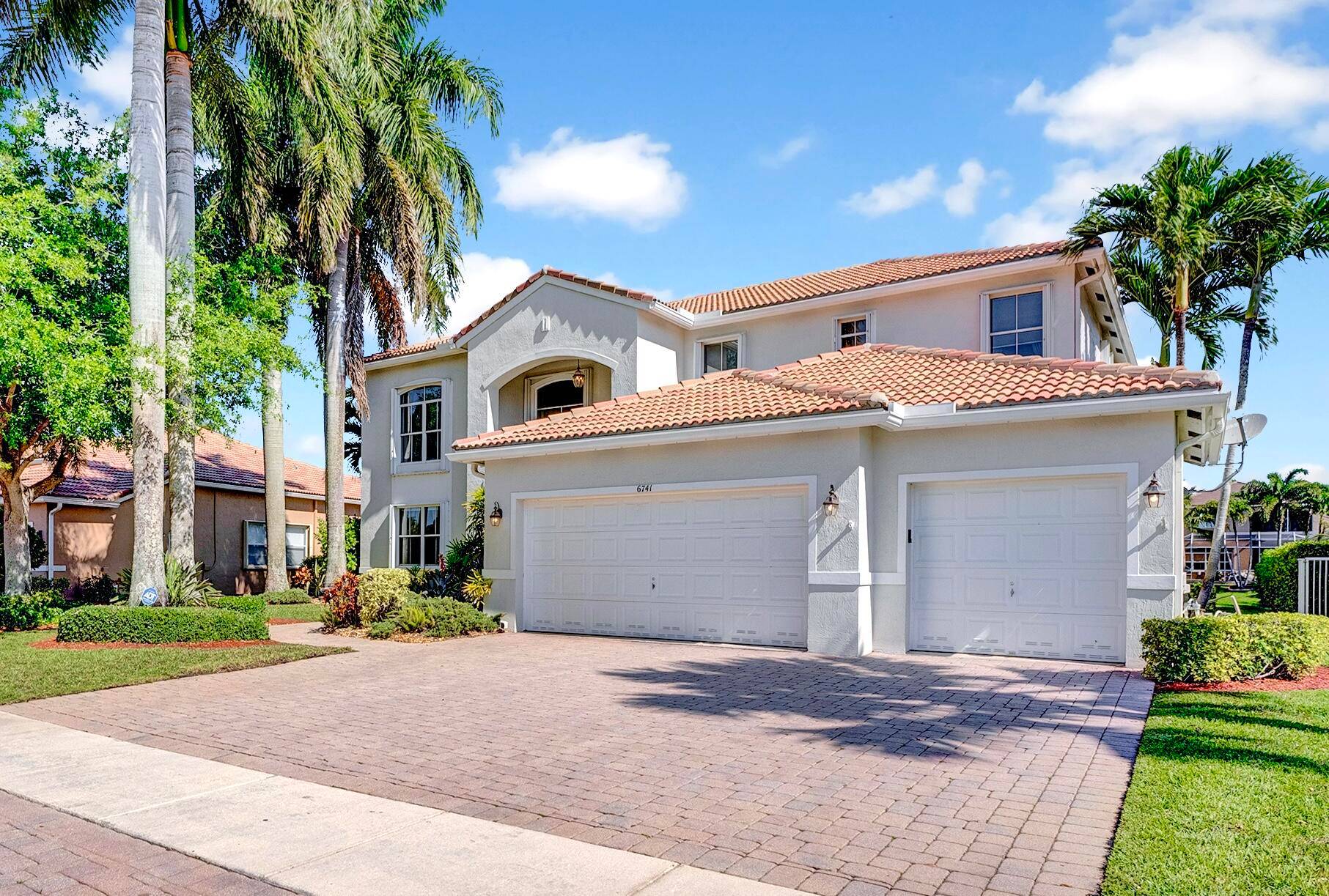 Expansive and filled with natural light, this two story pool home offers serene lake views in the highly sought after gated community of Journey's End.