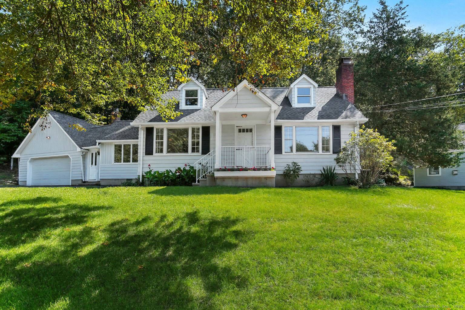 Thoughtfully expanded Cape Cod home in the Lake Hills area, featuring a spacious main level primary suite and 3 additional bedrooms.
