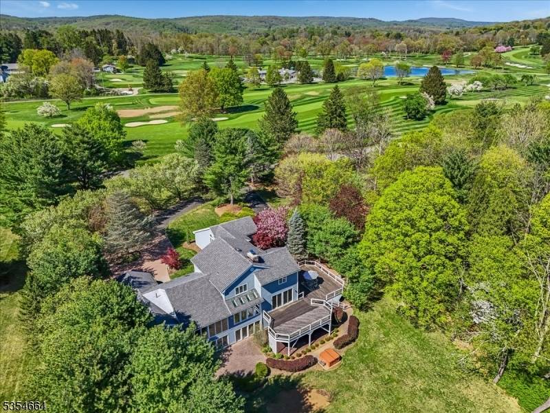 Situated directly across from the prestigious Mendham Golf Tennis Club, this exceptional estate is a true haven for golf enthusiasts.