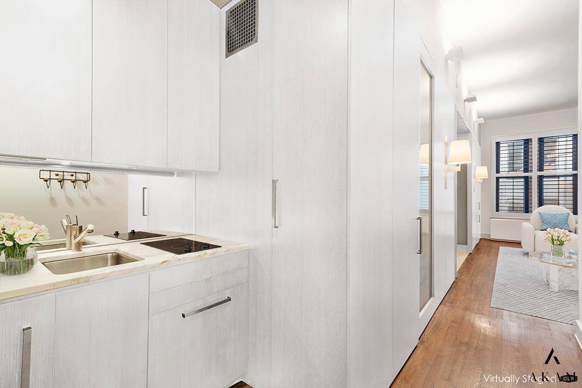 This sleek and modern loft like one bedroom, with its custom wood finishes and smart storage throughout was originally designed by Architect David Howell.