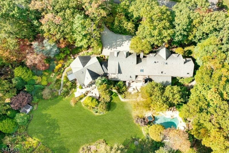 Breathtaking in every way, this extraordinary Manor Colonial is set on 2 private, tree lined acres.