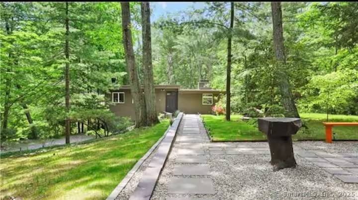 Welcome to 11 Alewives Rd a beautifully updated Mid Century Modern retreat blending comfort, character, and unmatched convenience.