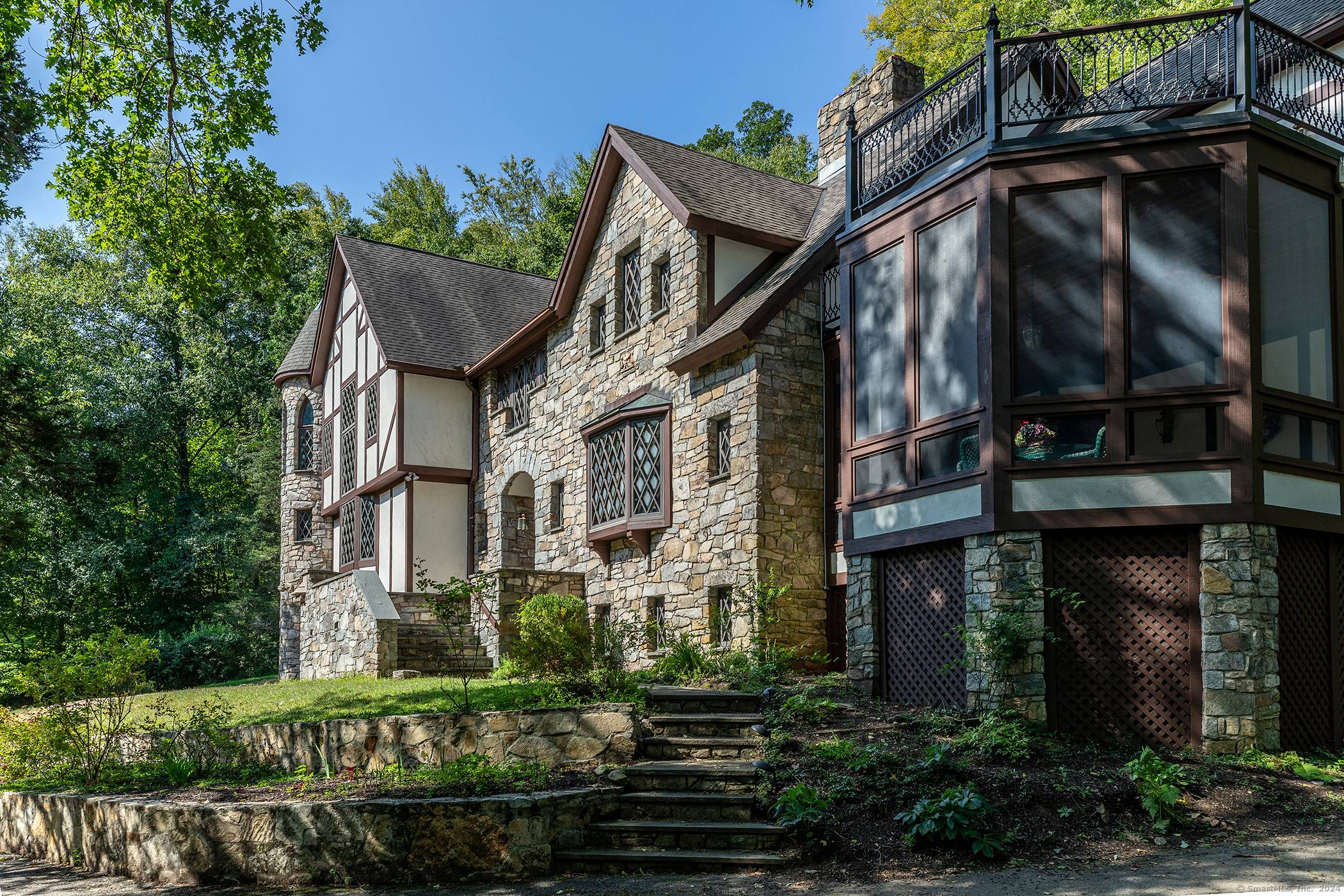 You'll find this Tudor and Stucco style home nestled on 8 private acres with a pond, on a private road in the picturesque town of Kent, CT.