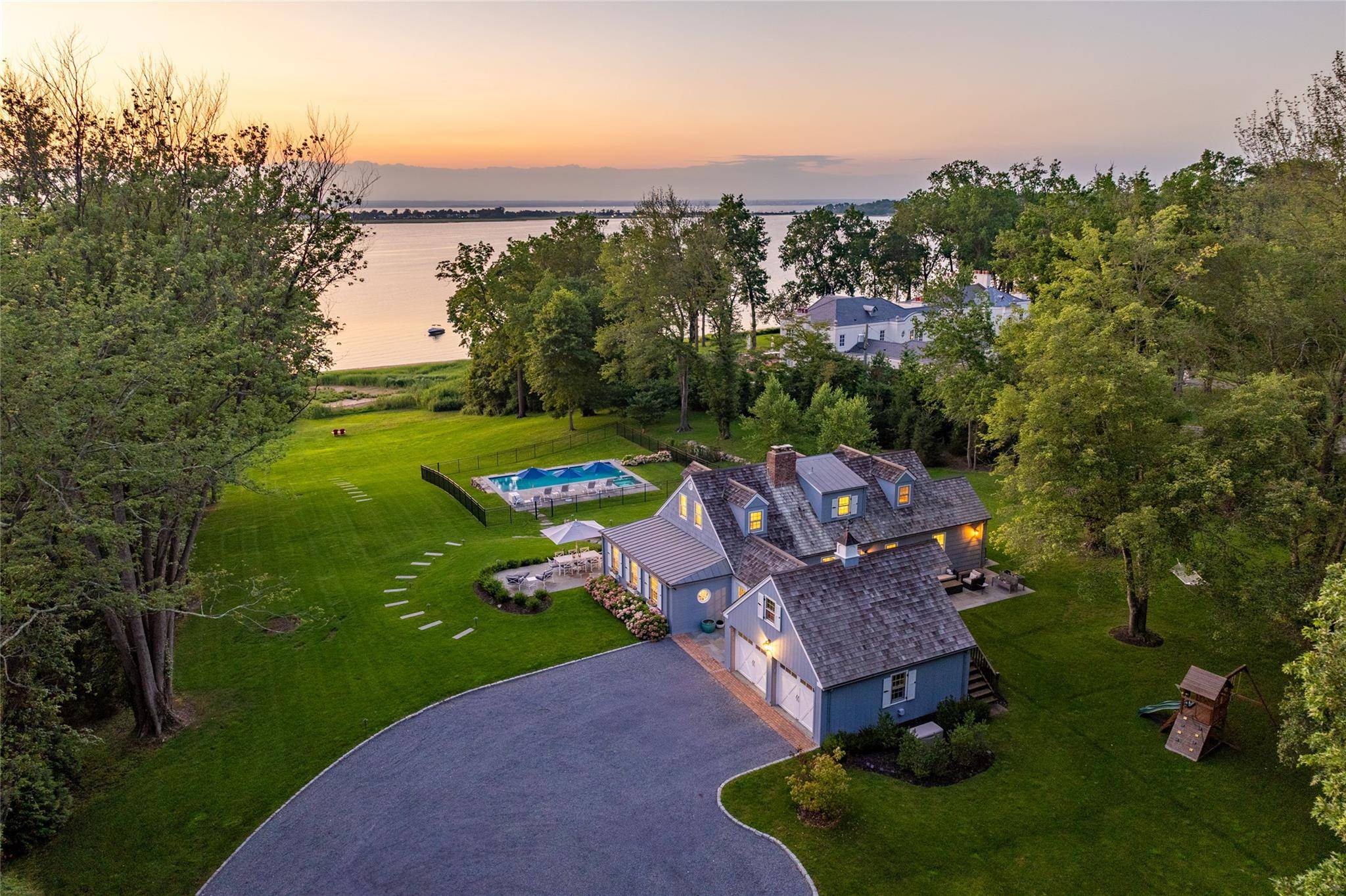 Tranquility Discover the epitome of waterfront living in this meticulously renovated Hampton style home, where every sunrise and sunset becomes your personal masterpiece.