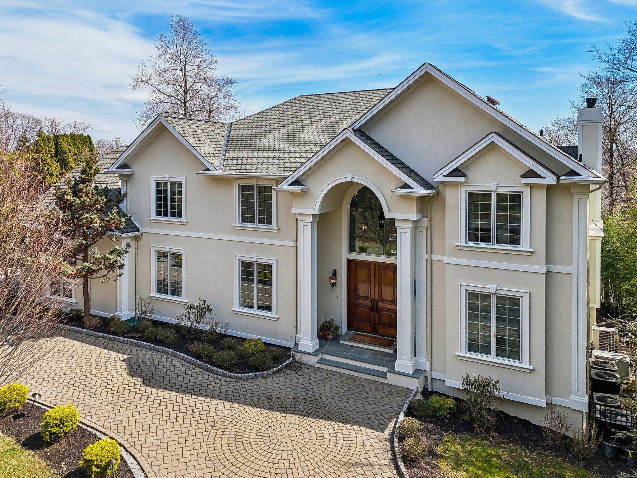 Nestled in a private and serene setting, this exceptional Contemporary Colonial offers over 5, 000 sq.