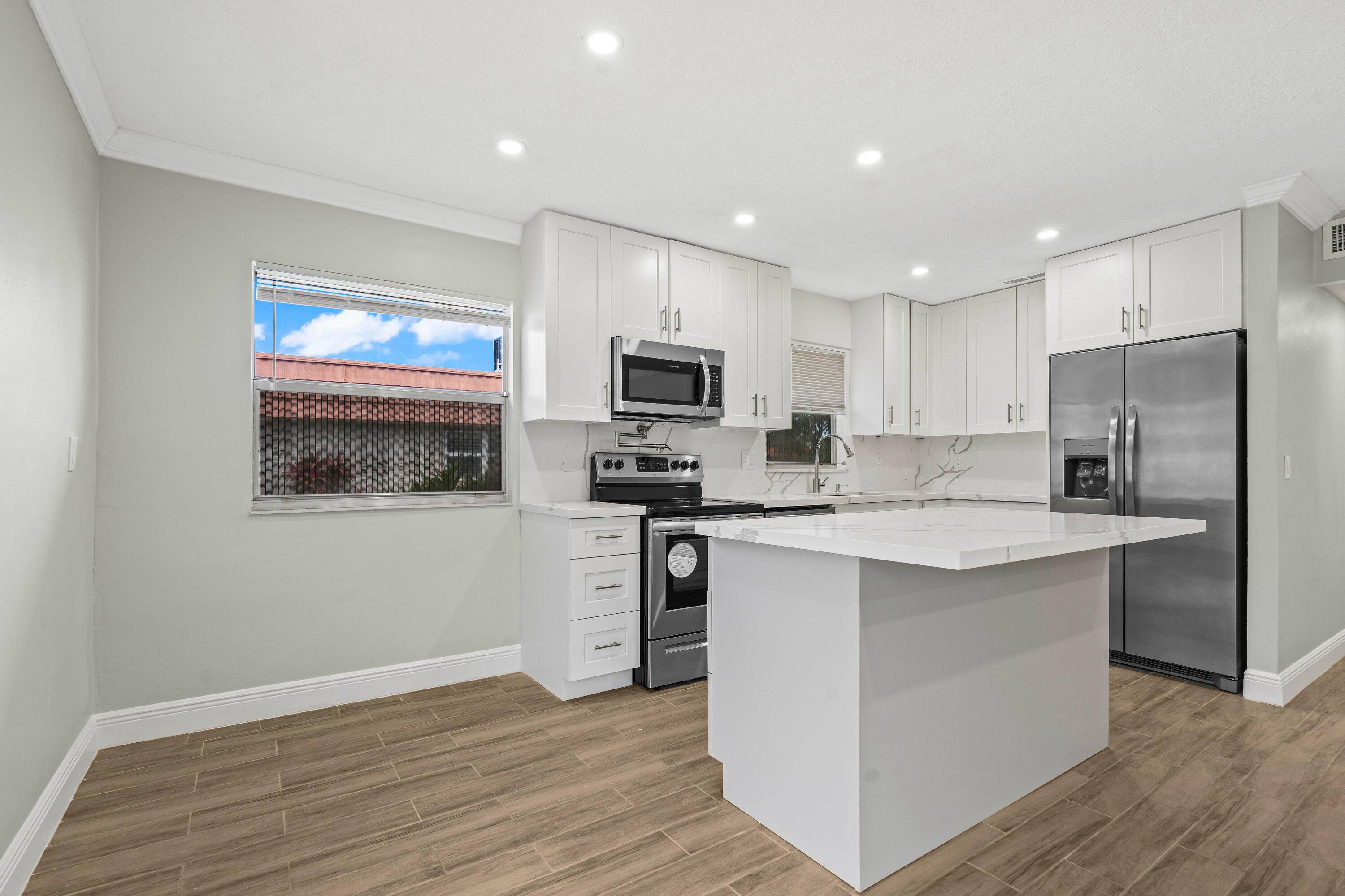 This completely remodeled villa in the desirable 55 community of Kings Point features a light bright kitchen with quartz countertops and brand new appliances.