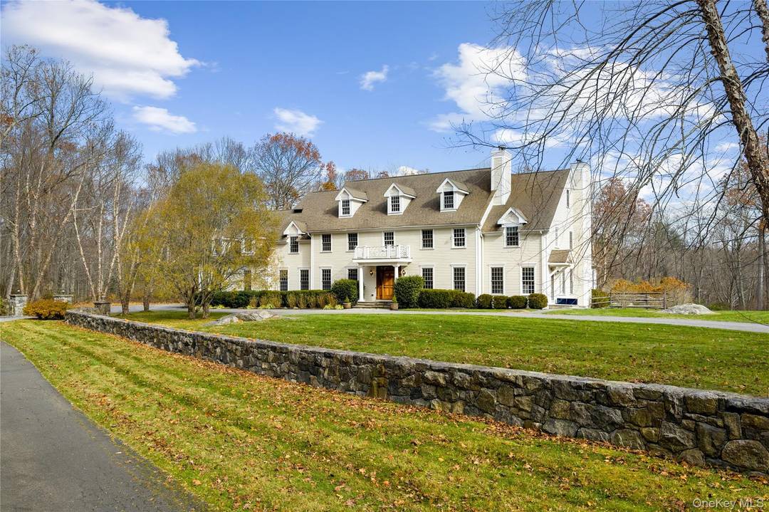 Set on over two spectacular acres in a premier location in Pound Ridge, this custom built Colonial offers an extraordinary blend of scale, craftsmanship, and complete privacy.