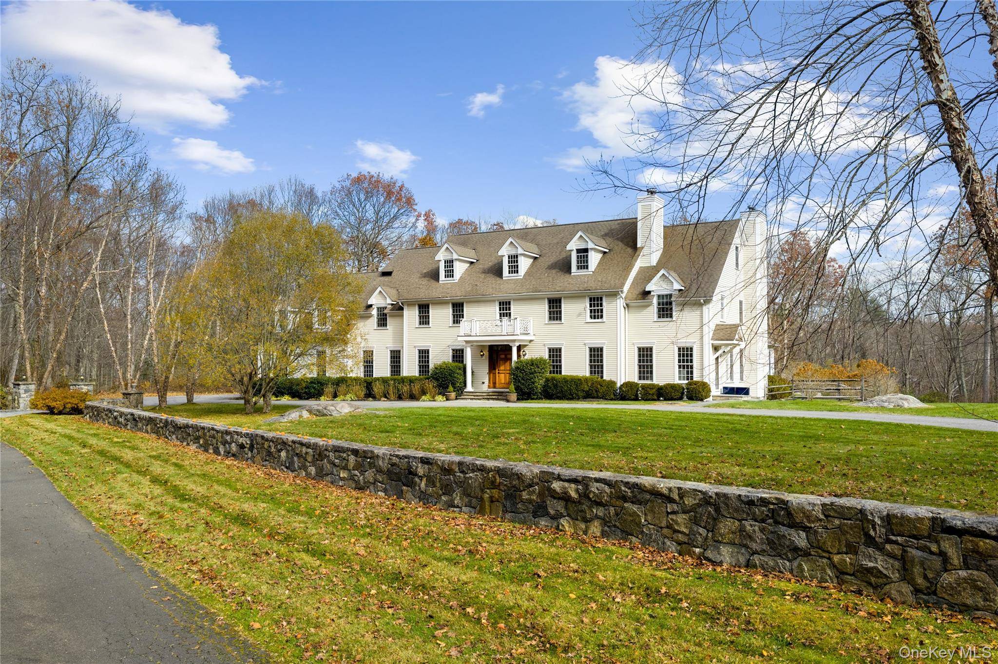 Set on over two spectacular acres in a premier location in Pound Ridge, this custom built Colonial offers an extraordinary blend of scale, craftsmanship, and complete privacy.