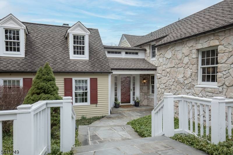Set upon Hilltop Road in Mendham Borough, this exceptional country property showcases four gently rolling acres with captivating sunset views enjoyed both outdoors and through a dramatic wall of glass.