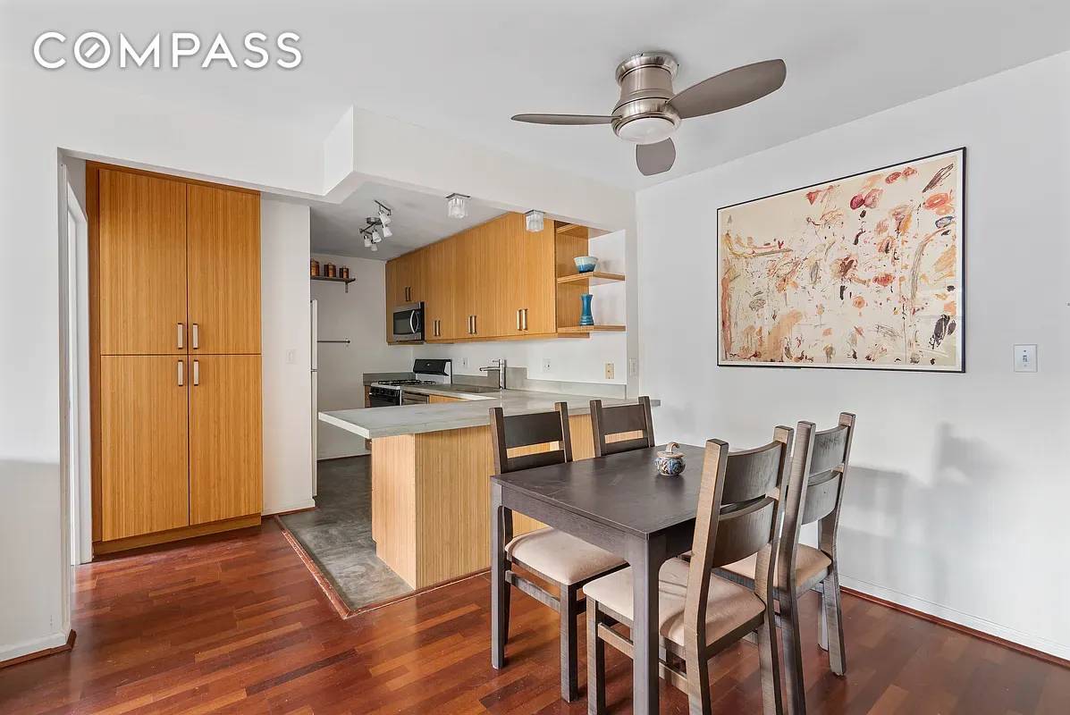 This home has undergone an environmentally conscious kitchen renovation, featuring sustainable materials such as solid bamboo cabinetry, Marmoleum flooring, and custom designed concrete sink and countertops.