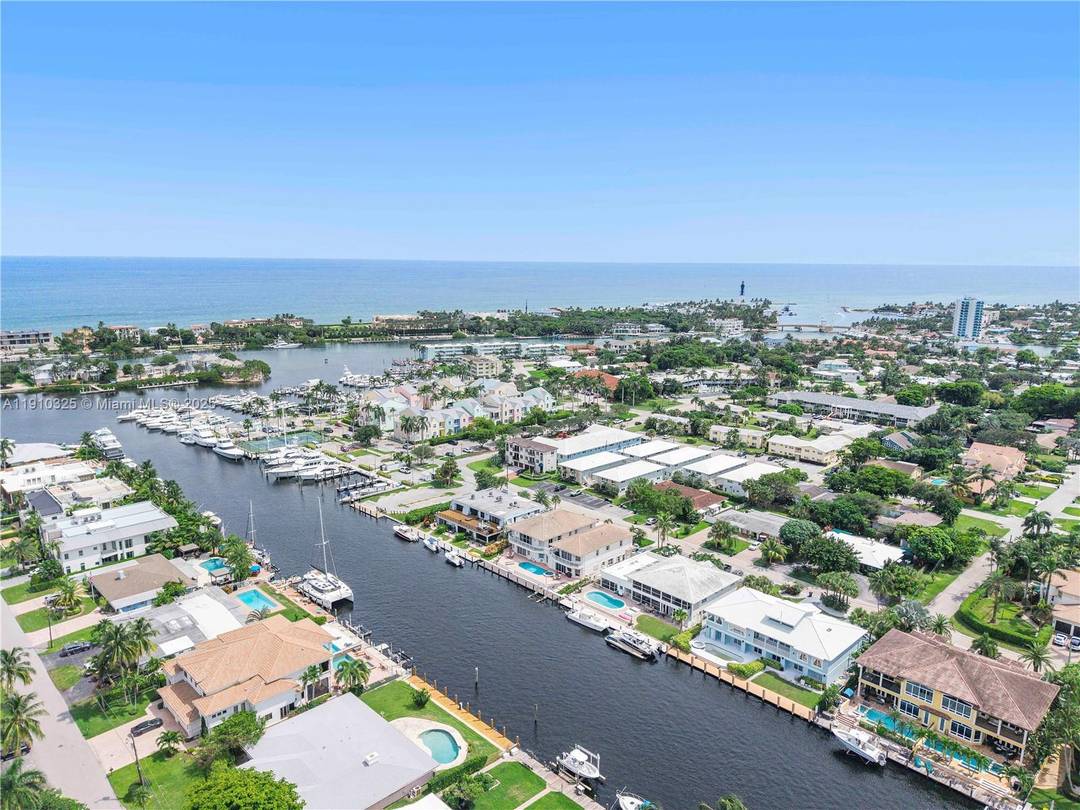JUST REDUCED ! Rarely available corner residence at Royal Palm Arms in Lighthouse Point, situated on one of the widest canals with direct access to the Hillsboro Inlet.