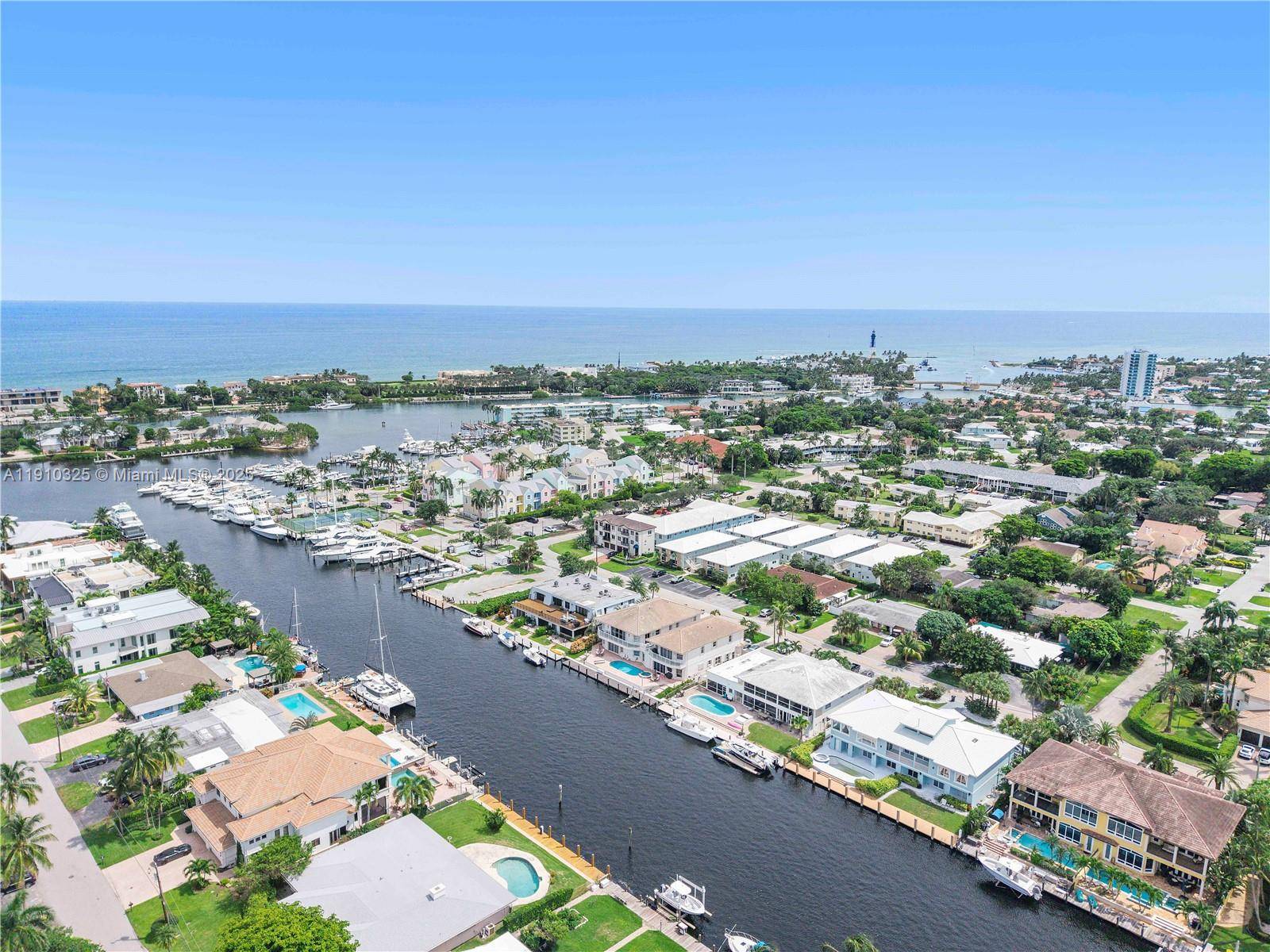 Experience waterfront living at its finest in this rarely available corner residence at Royal Palm Arms in Lighthouse Point.