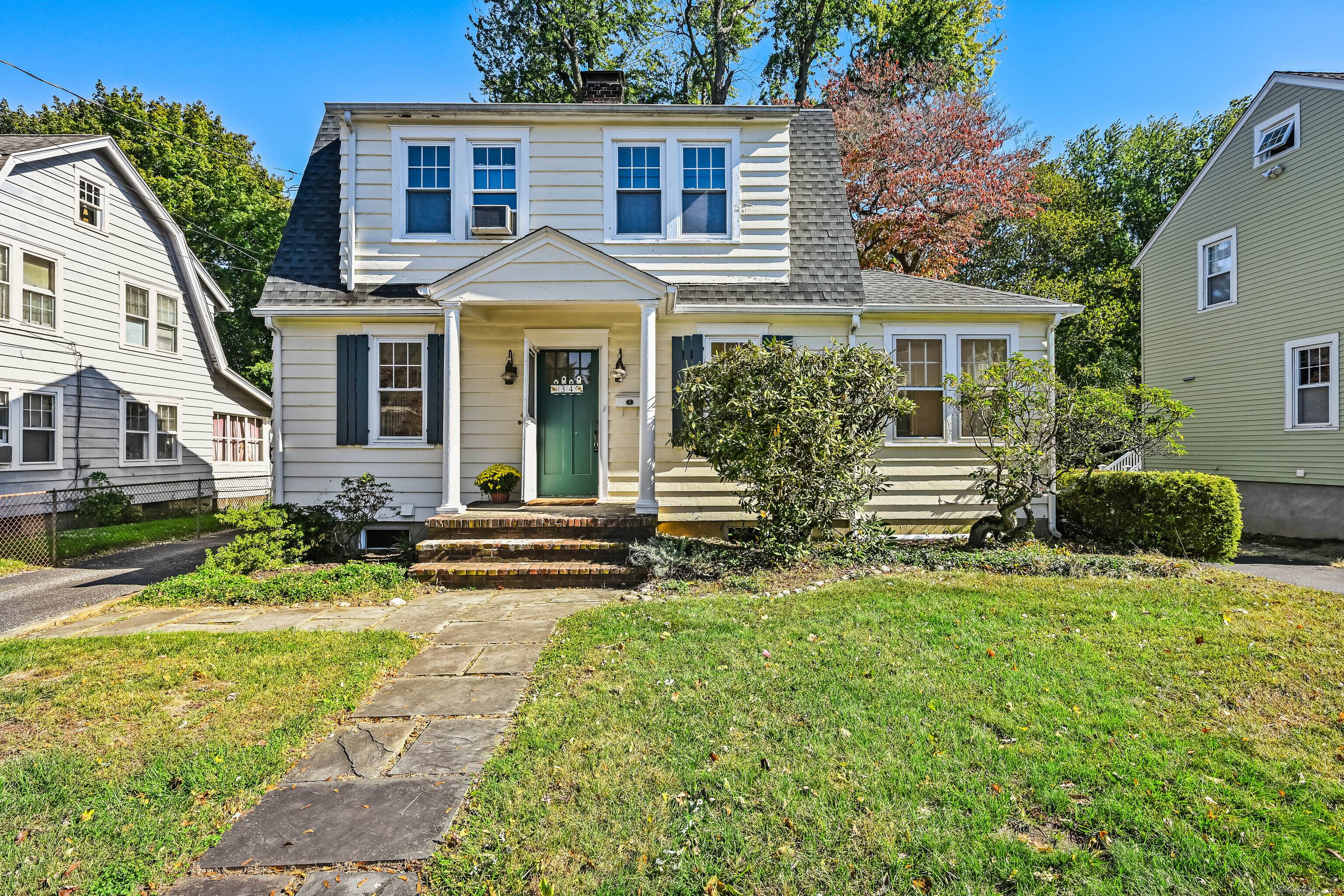 A classic 1920 Colonial home filled with character and charm of another era on a quiet street.
