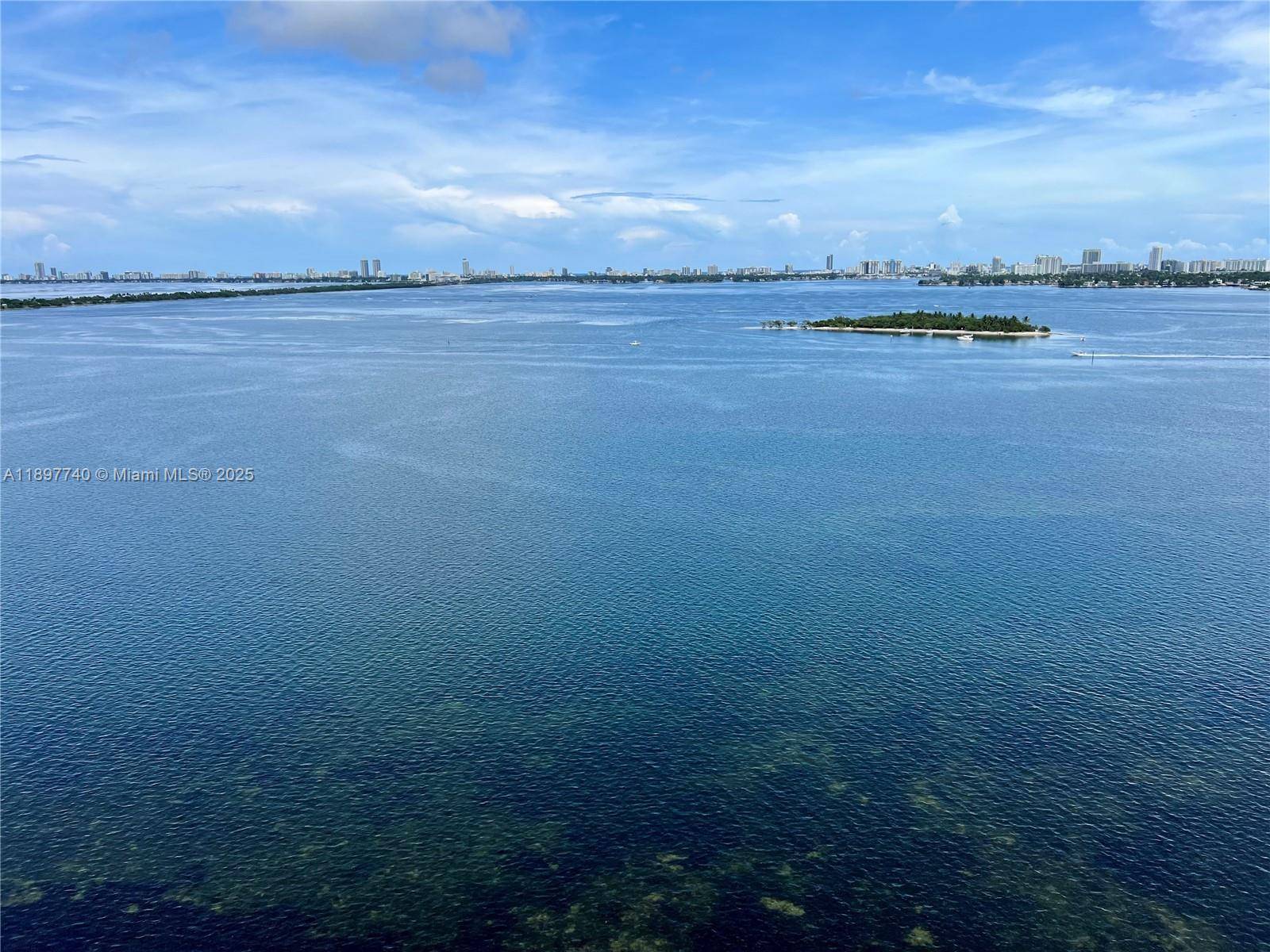 Experience elevated waterfront living in this modern 1BR den, 2BA residence on the 19th floor of Aria Reserve.