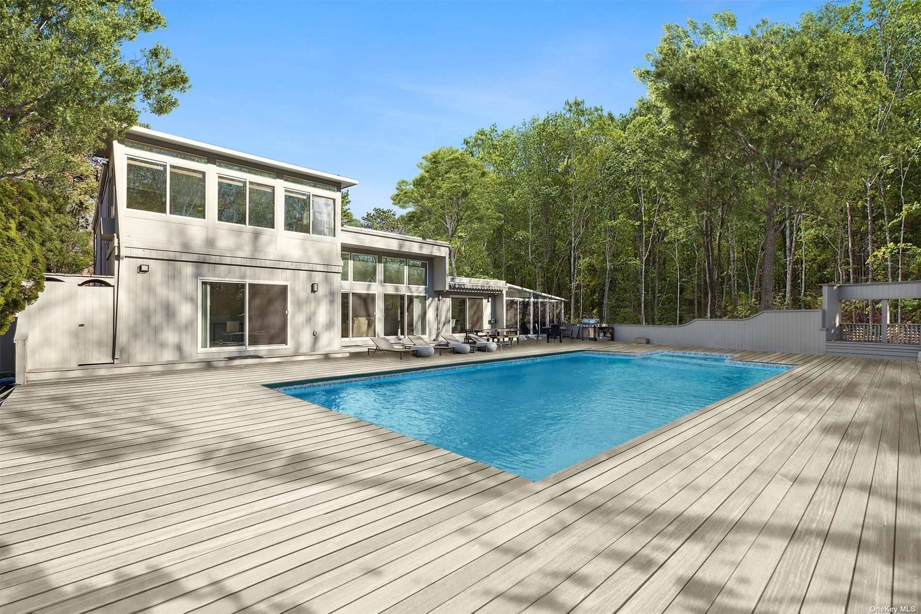 Located within the sought after neighborhood of East Quogue in the Hamptons, the picturesque estate at 32 Fox Hollow Drive stands as an epitome of luxury living.