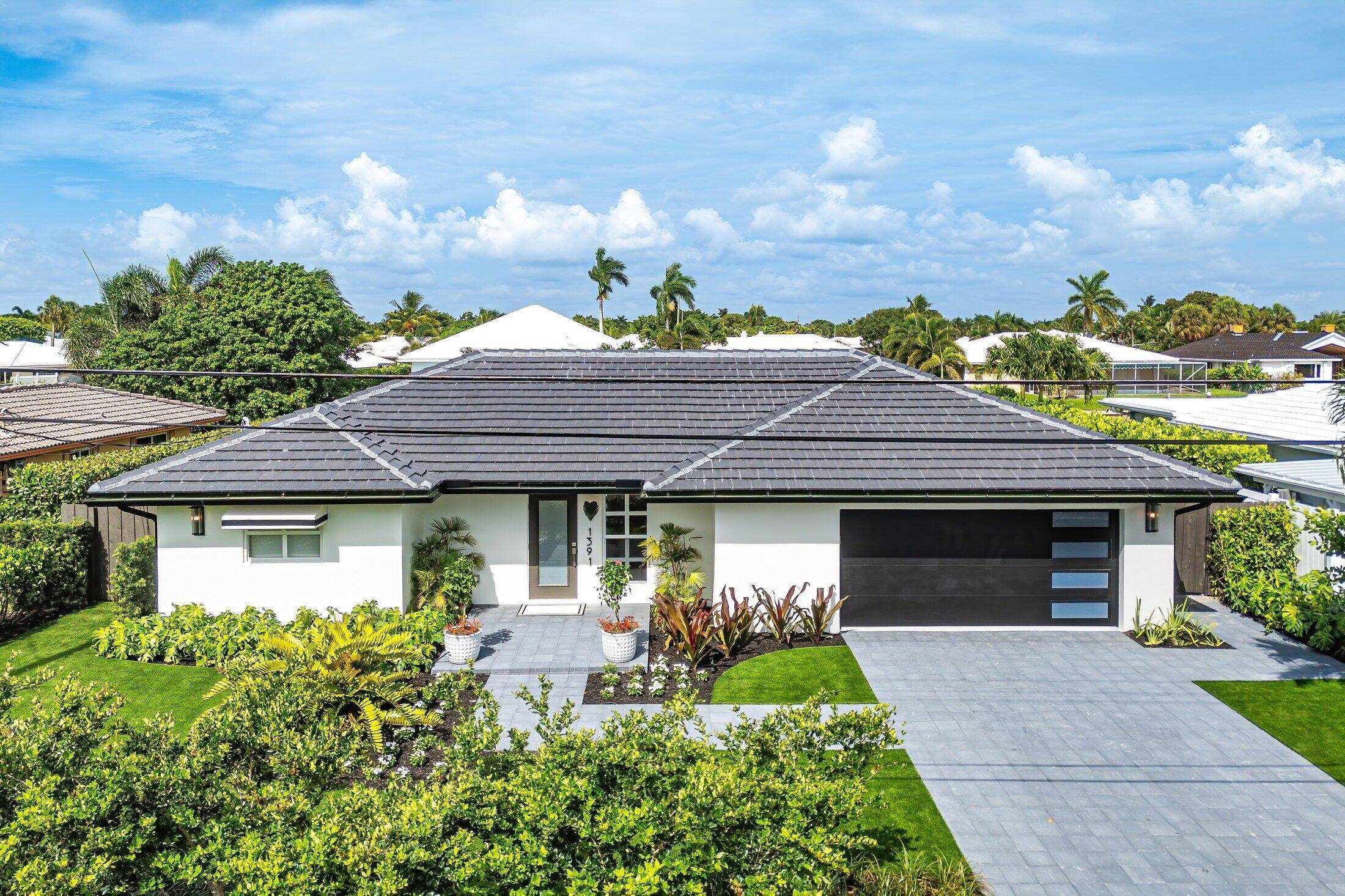 Meticulously renovated chic waterfront home on East Boca's El Rio natural waterway with ocean access under two fixed bridges.