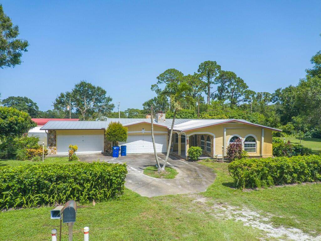 This Huge 1 acre corner lot is a fully equipped compound ready for abundant living, privacy and accessibility.