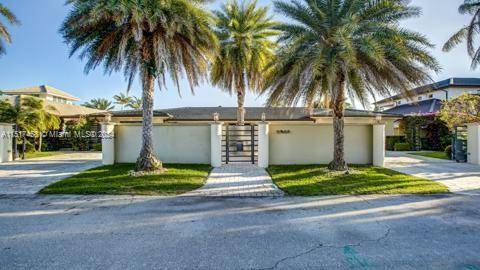 This amazing contemporary home built on 2 lots with large open design, allowing all glass doors to flow openly into the upscale pool and fully equipped outdoor barbecue bar area.
