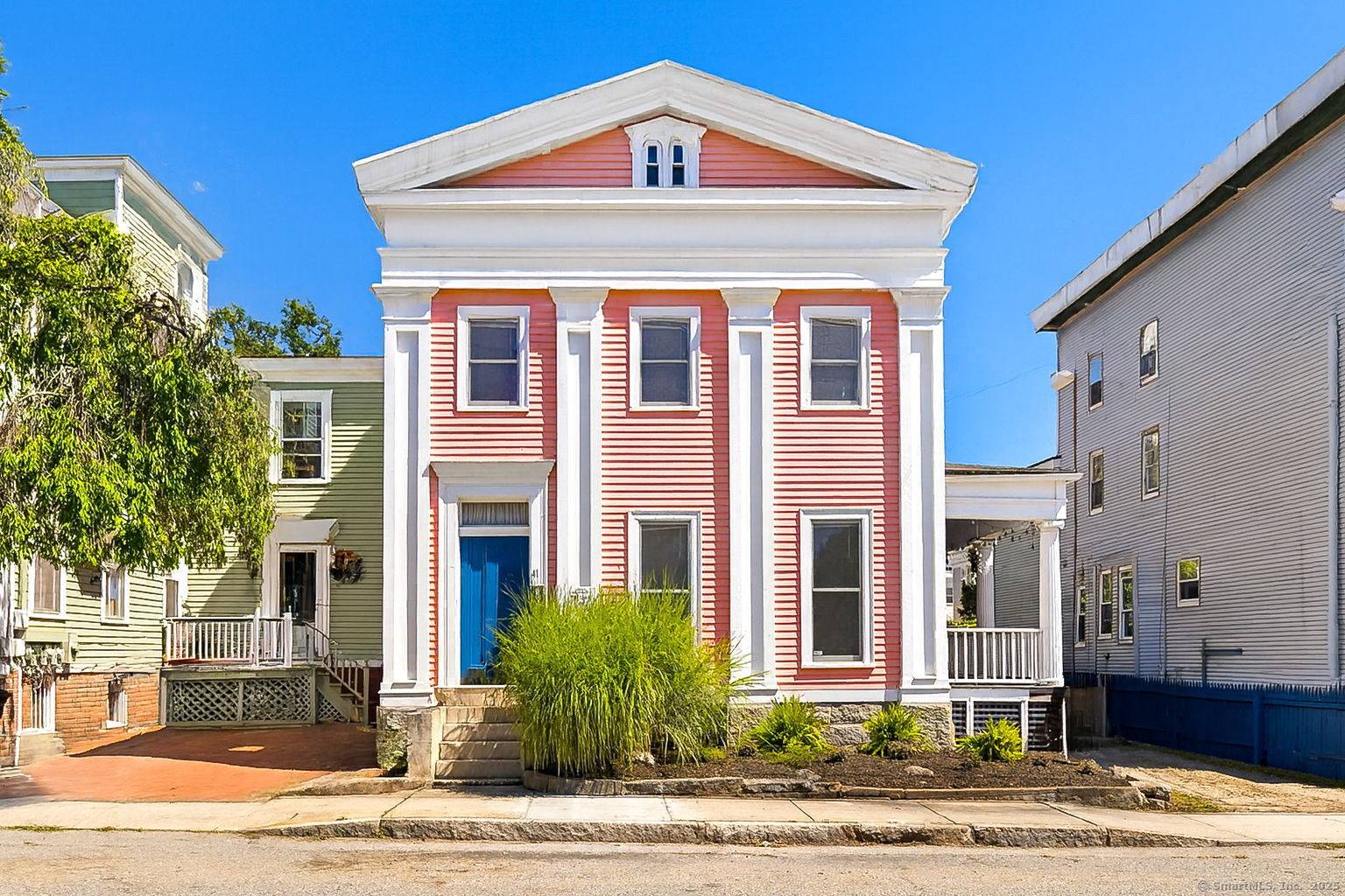 Welcome to 41 Tilley St a stately, artist loved Colonial with an eye catching pink exterior welcoming blue door in New London's Historic District.