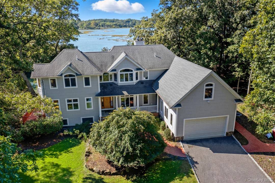 Discover an extraordinary opportunity to live at 22 Flax Pond Woods Road in Setauket, a spacious four bedroom, four bathroom residence set directly on the scenic shores of Flax Pond.