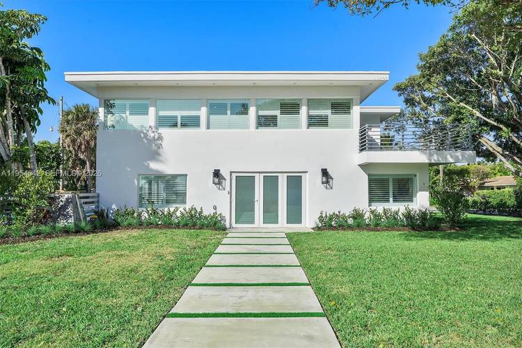 Experience coastal perfection in this masterfully reimagined Hillsboro Shores estate.