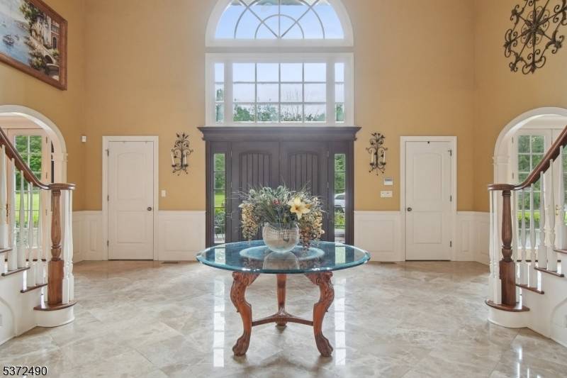 Welcome to this magnificent custom Colonial estate, gracefully set on over 10 acres of pristine land.