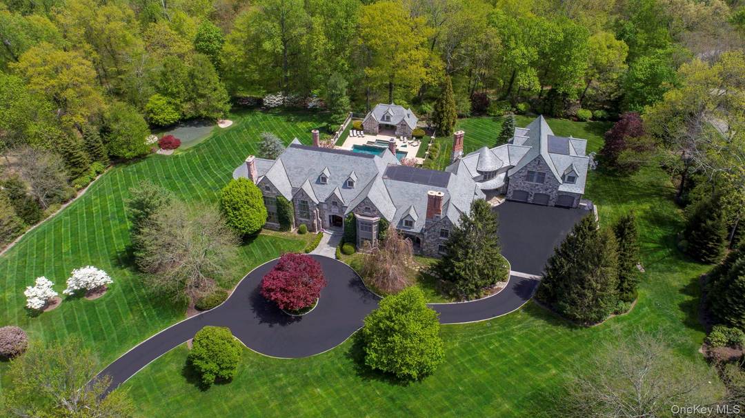 Behind the gates of one of Bedford's most exclusive enclaves, rises this breathtaking English Manor estate designed by renowned architect Tasos Kokoris.