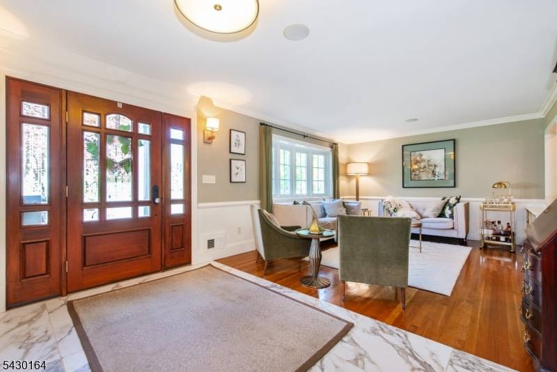 Elegant, pristine deceivingly large custom split level on a phenomenal street near Echo Lake CC !