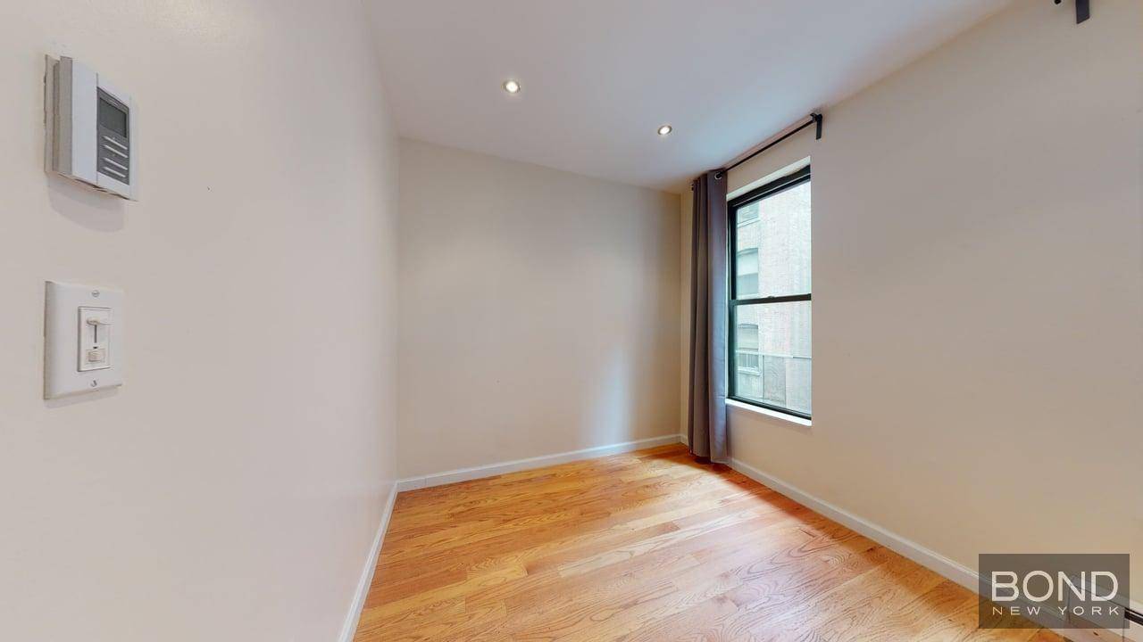 Large open Eat In kitchen with white marble counter top and Stainless Steel appliances.