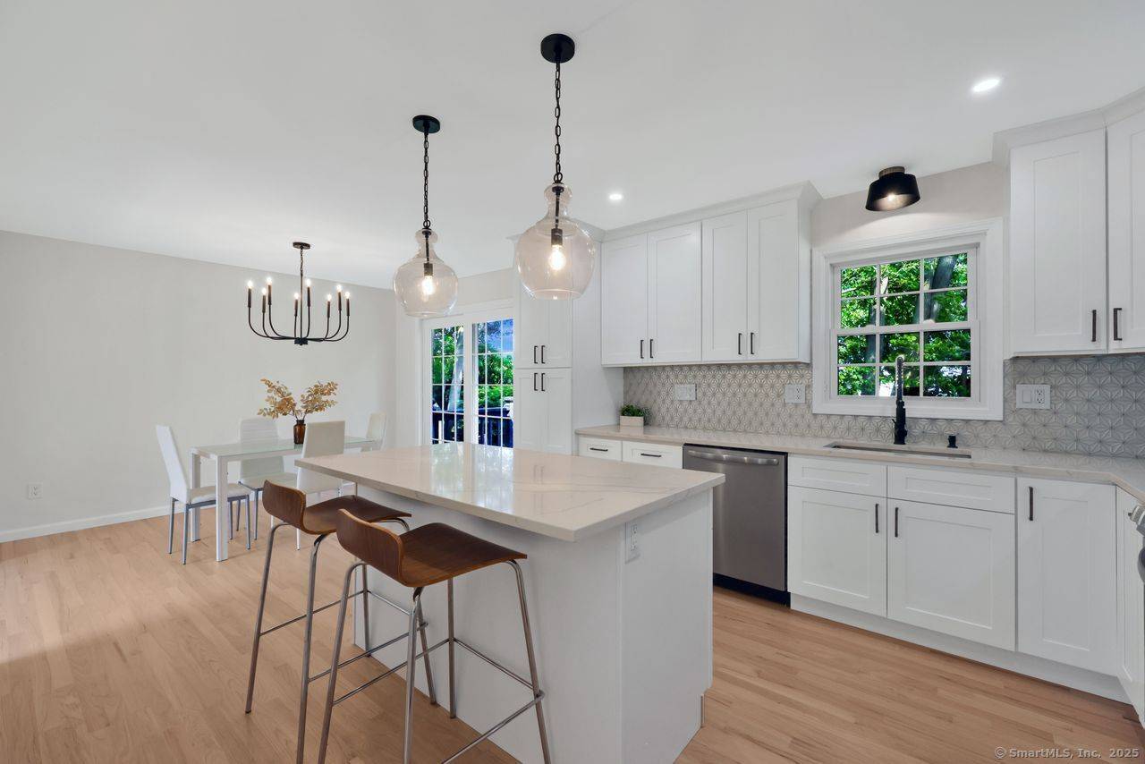 Step into luxury with this stunning raised ranch, nestled in a serene cul de sac between Walnut and Silver Sands Beach.