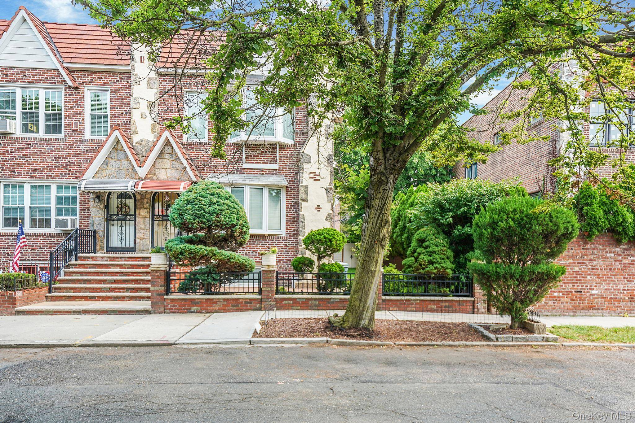Welcome to this rare semi detached legal two family Tudor home, perfectly situated in the heart of Middle Village.