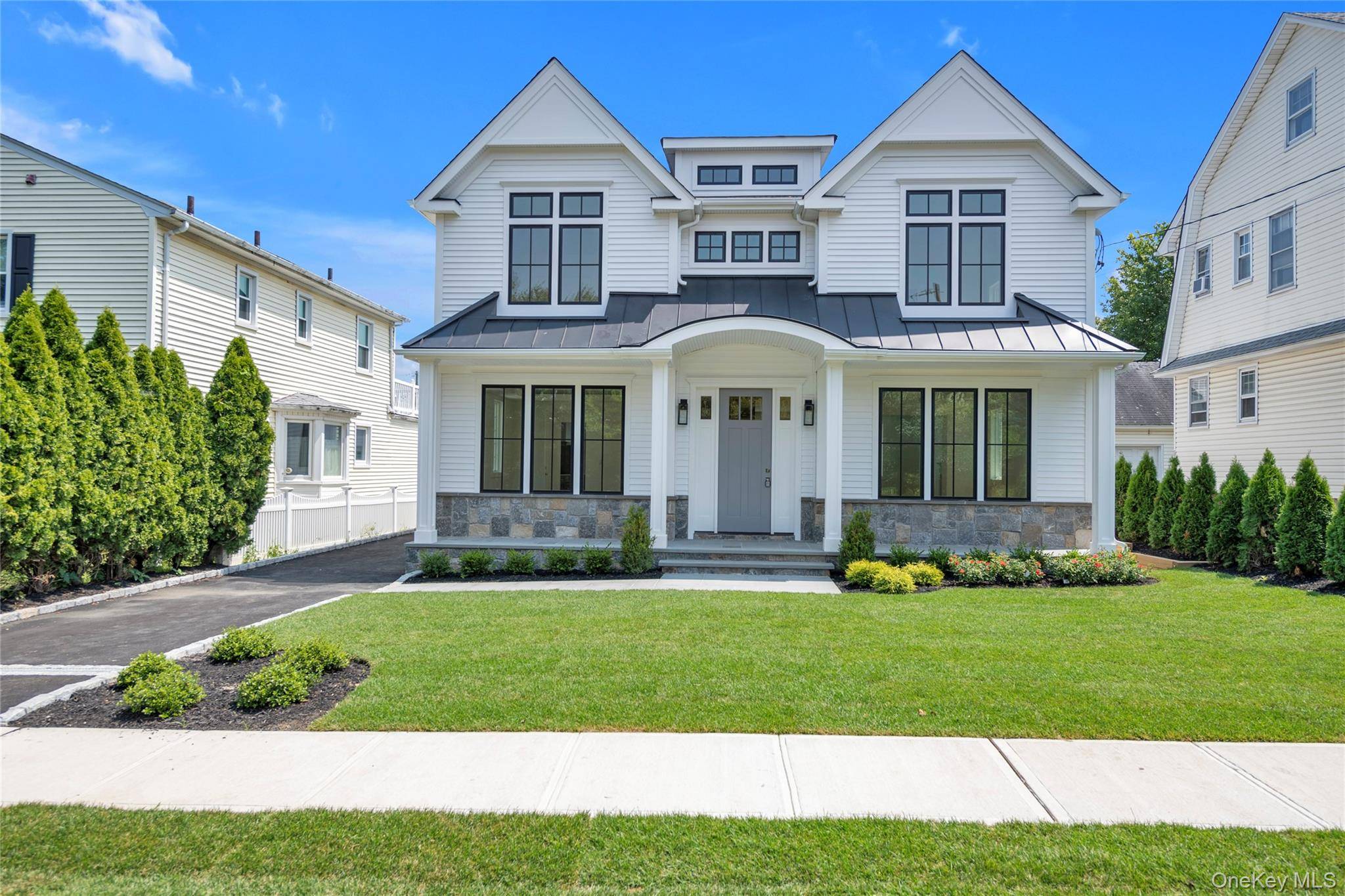 Stunning new construction in the heart of Manhasset, just steps to town and train.