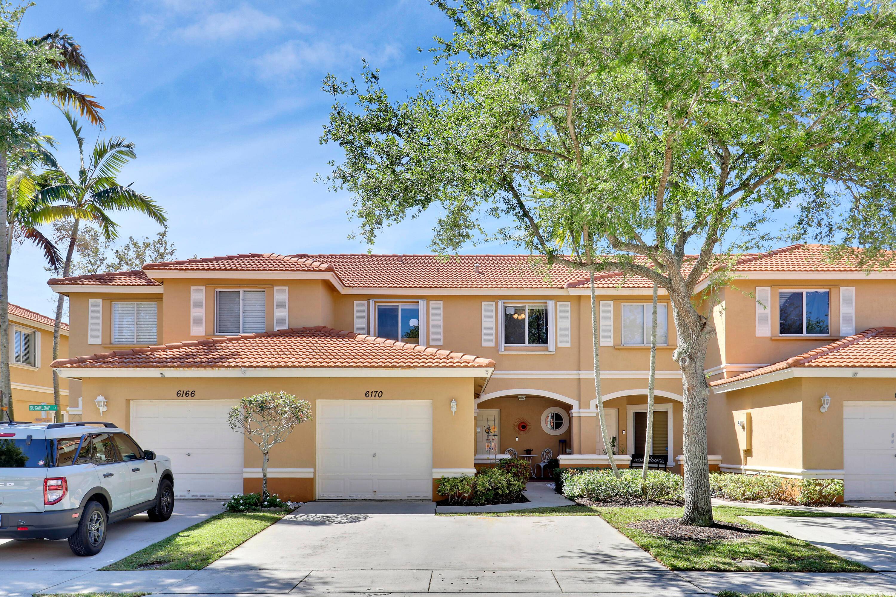 Welcome to 6170 Sugar Loaf Lane, a charming townhome nestled in BRIAR BAY, a highly sought after guard gated community in West Palm Beach.