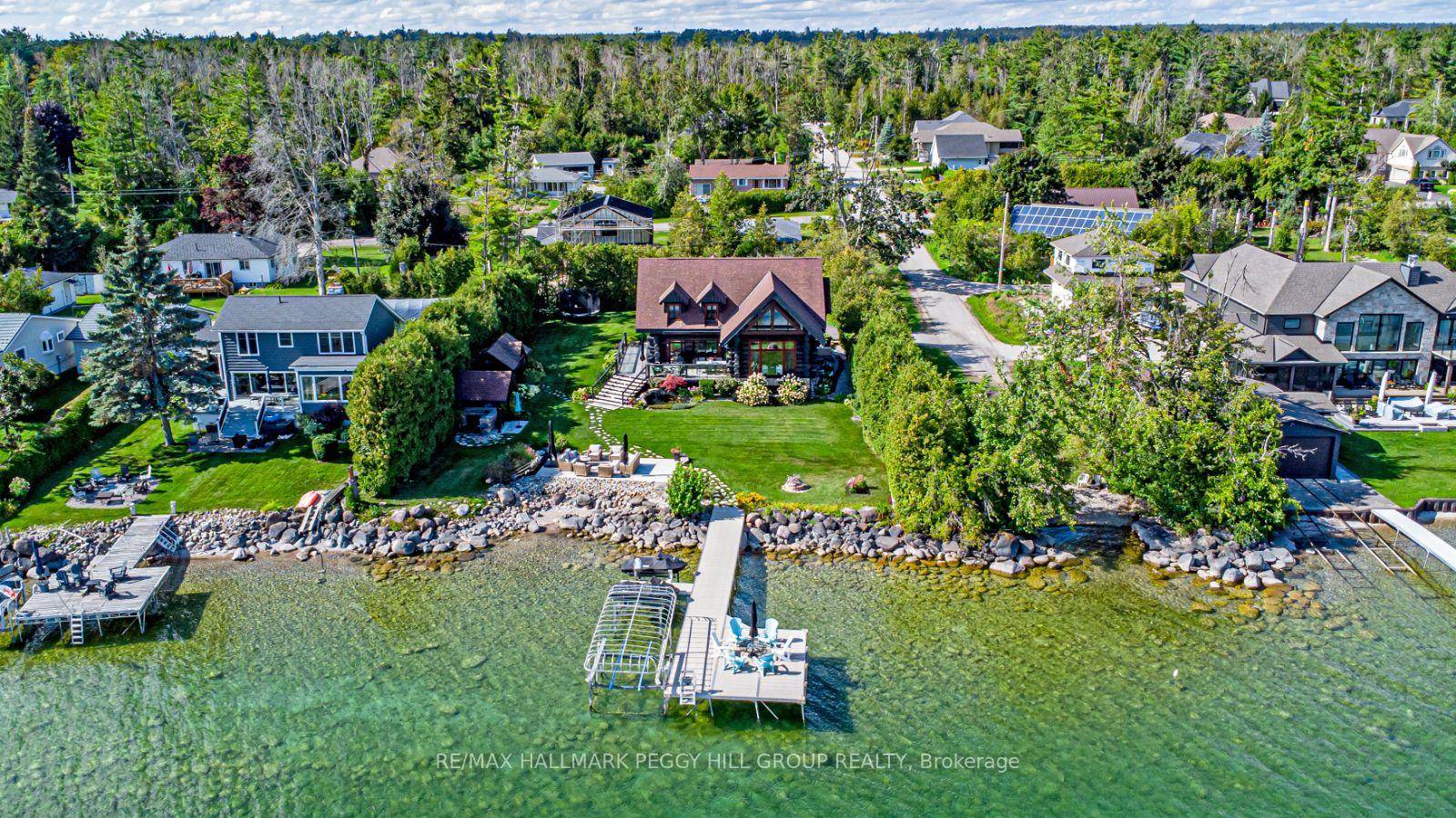 FULLY RENOVATED WATERFRONT MASTERPIECE WITH 100 FT OF PRIVATE SHORELINE, A LUXURY GUEST HOUSE, amp ; METICULOUSLY LANDSCAPED RESORT STYLE GROUNDS !
