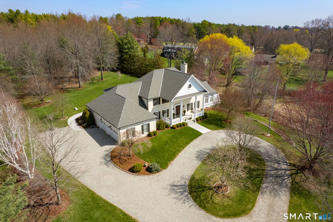 Nestled on 4 private acres at the end of a quiet cul de sac in Suffield, this magnificent 1993 built Georgian Colonial offers a commanding presence with an elegant tree ...