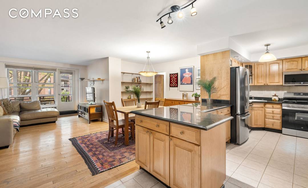 Apartment 2E is a warm, inviting, updated home that is great for entertaining, with its open kitchen and recently installed stainless steel appliances.